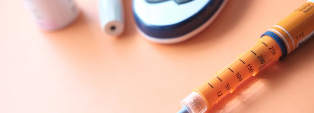 Weightloss injection lying on table next to other diabetes tools