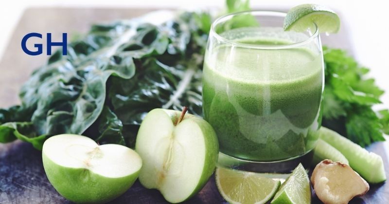 Glass of green juice and vegetables for juice cleanse trend as recent fad diet proven to be ineffective for health and long term weight loss. Higa Bariatrics logo at top left. 
