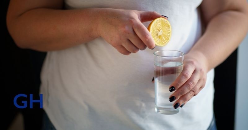 Woman adds a squeeze of lemon to her water to help add flavor when she is trying to stay hydrated after weight loss surgery with Dr. Guillermo Higa