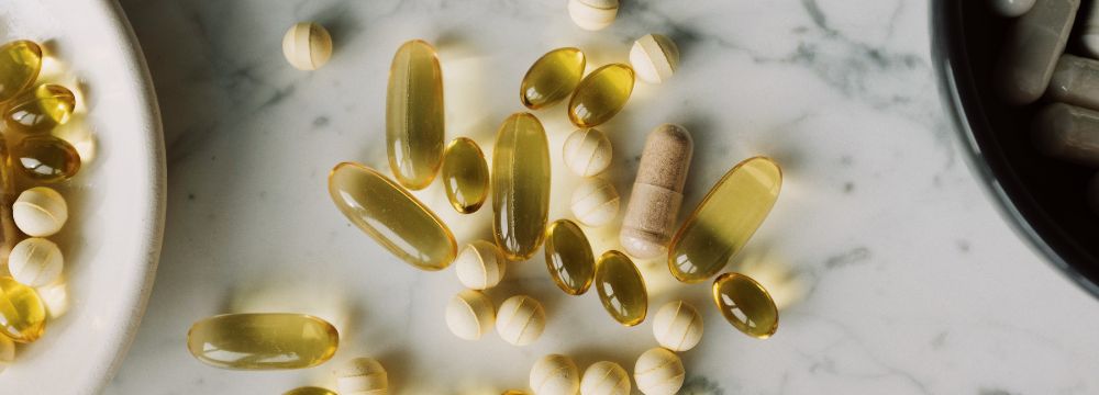 vitamin D supplements in pile on countertop