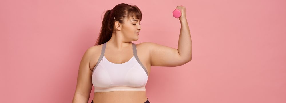 woman flexing with weight after bariatric surgery